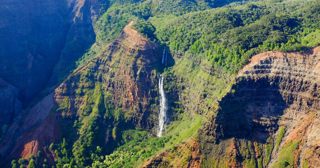 kauai helicopter tour bird's eye view of cliffs and a waterfall