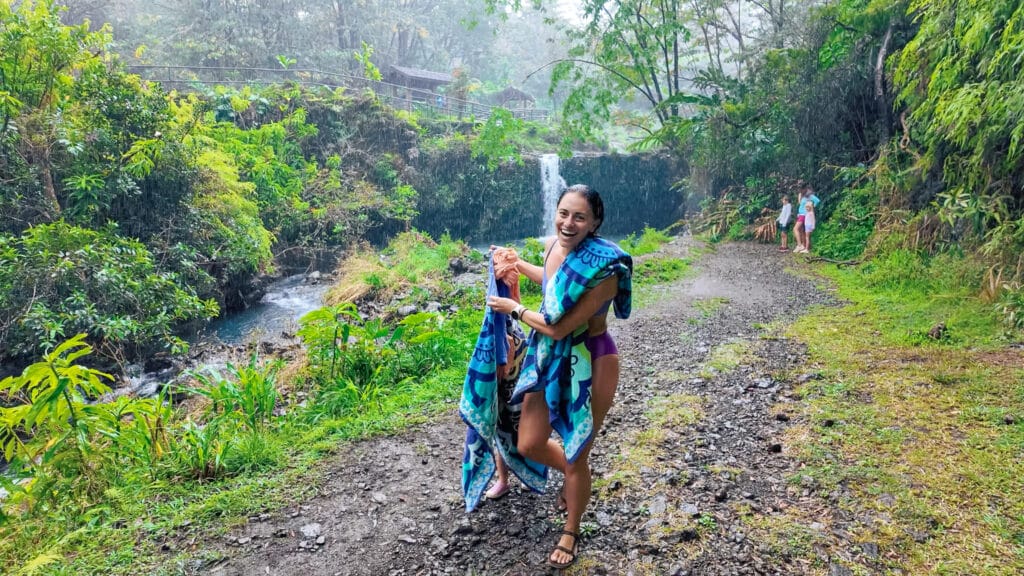summer weather in hawaii. erica in the rain on the road to hana